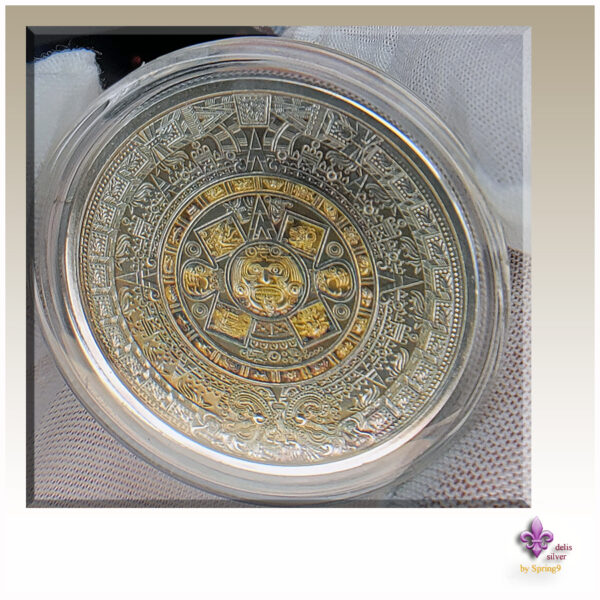 gilded Aztec Callendar coin in a capsule