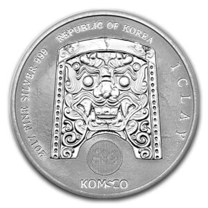 a silver coin with a face on it