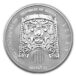a silver coin with a face on it