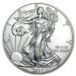 a silver coin with a woman holding a tree