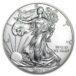 a silver coin with a woman holding a tree