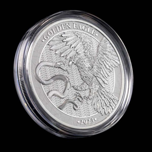 a silver coin with a picture of a bird and snake