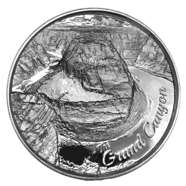 a silver coin with a picture of a canyon