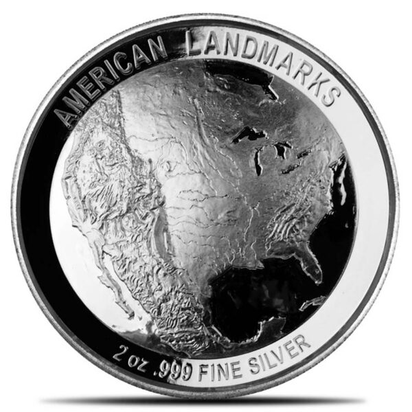 a silver coin with a map of the earth