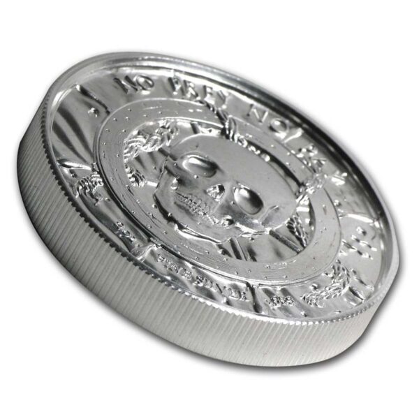 a silver coin with a skull on it