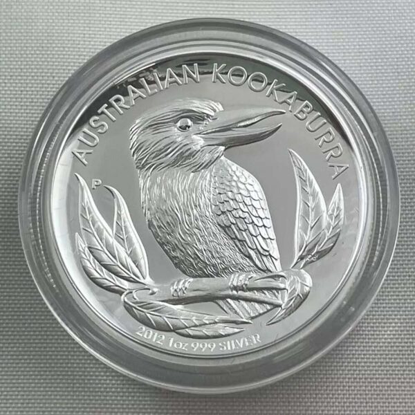 a silver coin with a bird