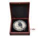 a silver coin in a box