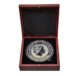 a silver coin in a wooden box