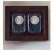 a pair of silver coins in a wooden frame